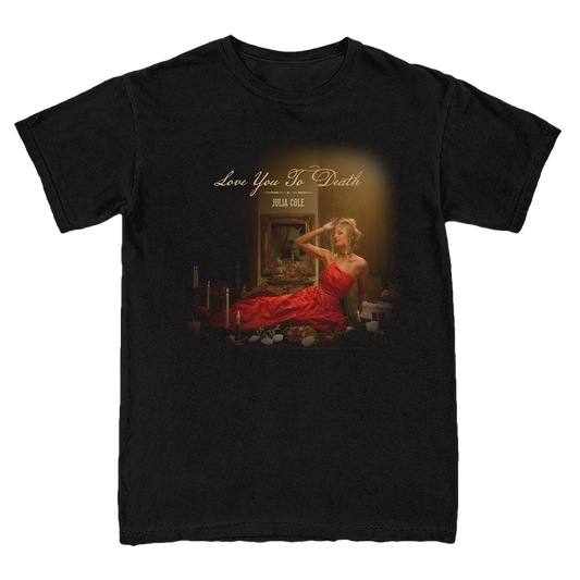 A black short-sleeve crewneck t-shirt featuring a graphic print of a Julia in a red dress sitting in a dark room with candles, with the text 'Love You To Death'